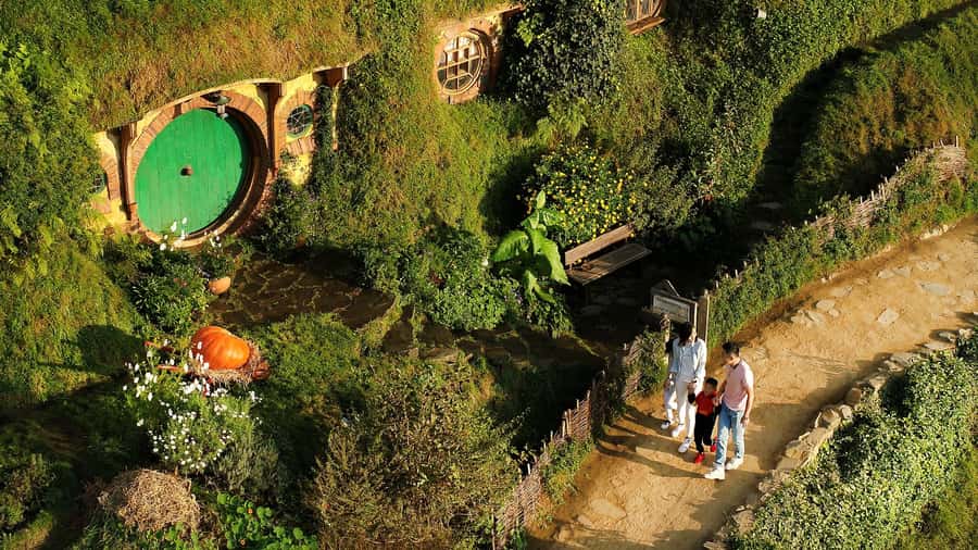From Rotorua: Hobbiton Movie Set Tour with Festive Lunch - Walking through the 12-acre Hobbiton set